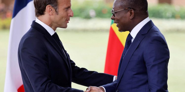 Beninese President Patrice Talon (R) and France's President Emmanuel Macron (L) shake hands at the end of a press conference at the presidential palace in Cotonou on July 27, 2022, as part of Macron's official visit in Benin. LUDOVIC MARIN / AFP