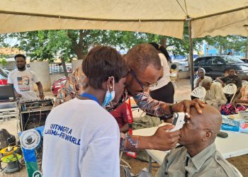 A patient being taken through a glaucoma test.