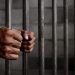 File image of a man behind bar