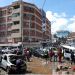 People stand around destroyed vehicles following flash floods caused by heavy rainfall in the Grogan area, popular for automotive workshops and secondhand spare parts, in downtown Nairobi, Kenya, March 7, 2026. REUTERS/Monicah Mwangi Purchase Licensing Rights