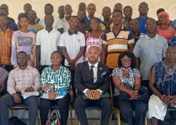 CHRAJ Head of Business and Human Rights, Clement Kadogbe(in suit) and some of the victims