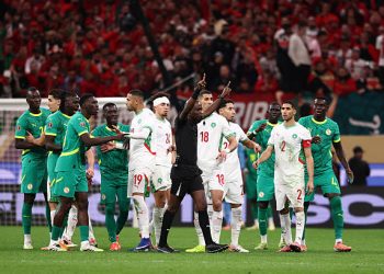 Congolese referee Jean-Jacques Ndala Ngambo calls for a VAR decision during the Africa Cup of Nations (CAN) final football match between Senegal and Morocco at the Prince Moulay Abdellah Stadium in Rabat on January 18, 2026. (Photo by FRANCK FIFE / AFP via Getty Images)