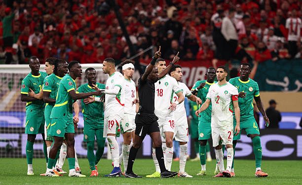 Congolese referee Jean-Jacques Ndala Ngambo calls for a VAR decision during the Africa Cup of Nations (CAN) final football match between Senegal and Morocco at the Prince Moulay Abdellah Stadium in Rabat on January 18, 2026. (Photo by FRANCK FIFE / AFP via Getty Images)