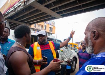 Accra Mayor Michael Kpakpo Allotey, (in reflector outfit), interacting with residents under the Kaneshie Footbridge