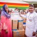 Sagnarigu MP, Atta Issah presenting sewing machine to a constituent