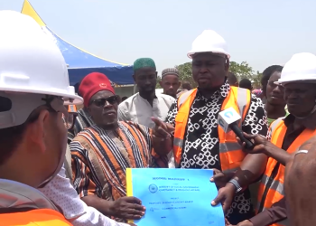 Savannah Regional Minister, Salisu Be-Awuribe handing over the site for the construction of a 24-hour economy market to CK Engineering Company Limited
