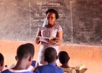 File Image of a teacher and student in a classroom setting