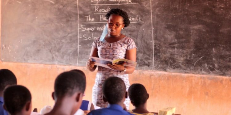 File Image of a teacher and student in a classroom setting