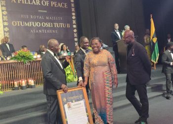 Deputy Chief of Staff , Nana Oye Bampoe Addo receiving President Mahama's award on his behalf