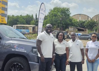 Managing Director of SIC Insurance PLC, James Agyenim-Boateng [right] with officials of WanderLust Expedition.