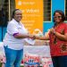 Ms Juliet Amuah, Vice President of Olam Agri’s empOWer hands over assorted products to a management representative of HopeSetters Autism Centre.