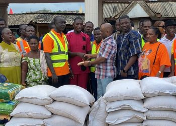 Member of Parliament for Abura-Asebu-Kwamankese, Felix Ofosu Kwakye donating items and cash to the victims
