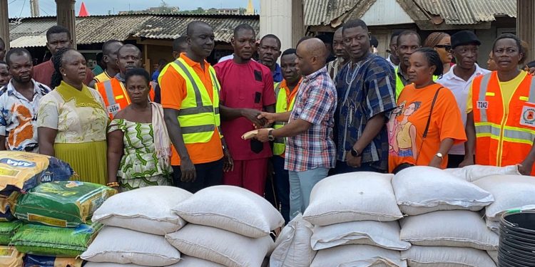 Member of Parliament for Abura-Asebu-Kwamankese, Felix Ofosu Kwakye donating items and cash to the victims