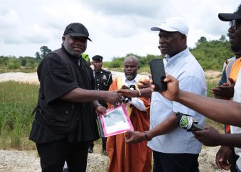 Minister for Lands and Natural Resources, Emmanuel Armah-Kofi Buah [right], handing over the documents to the Lead Operational Director of RM Ecorestore Ghana Limited, Nana Kyeame Ampratwum [left].