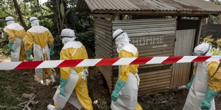 Doctors Without Borders teams wearing full protective equipment reinforce perimeter barriers around a restricted Ebola isolation zone and basic hygiene facilities, including toilets designated for suspected Ebola patients, at the General Referral Hospital of Mongbwalu on May 26, in Mongbwalu, Democratic Republic of Congo.
(Michel Lunanga/Getty Images)