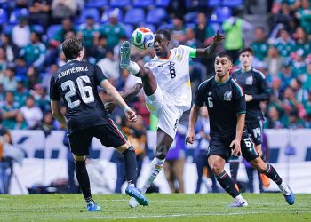 PUEBLA, MEXICO - MAY 22: Brian Gutierrez (L) and Erik Lira (R) of Mexico fight for the ball with Majeed Ashimeru (C) of Ghana during the international friendly match between Mexico and Ghana at Estadio Cuauhtemoc on May 22, 2026 in Puebla, Mexico. (Photo by Luis Cano/Jam Media/Getty Images)