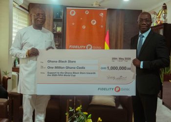 Julian Opuni, Managing Director (right) presenting the cheque to the Hon. Kofi Iddie Adams, Minsi (left) at a brief ceremoney at the Ministry of Sports and Recreation