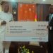 Julian Opuni, Managing Director (right) presenting the cheque to the Hon. Kofi Iddie Adams, Minsi (left) at a brief ceremoney at the Ministry of Sports and Recreation