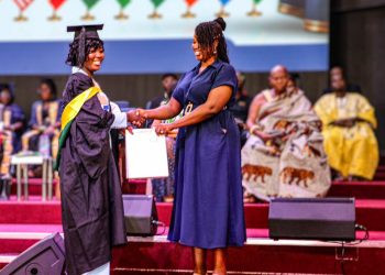 Mrs Millicent Otoo-Provencal, Communications Manager at Mahogany Consult [right], presenting the award to one of the graduates