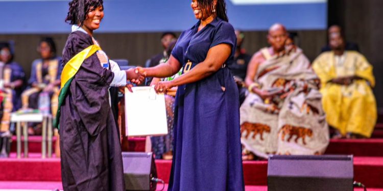 Mrs Millicent Otoo-Provencal, Communications Manager at Mahogany Consult [right], presenting the award to one of the graduates