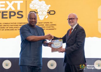 Dutch Ambassador H.E. Jeroen Verheul presenting a catalogue of the artefacts to President John Dramani Mahama