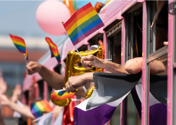 Parade participants wave to spectators during the Nashville Pride parade on 24 June 2023. Photograph: George Walker IV/AP