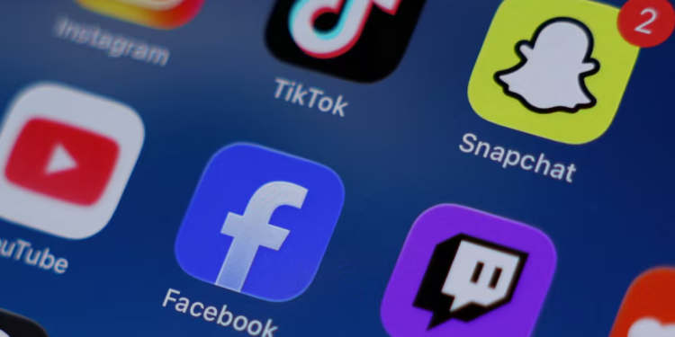 Instagram, TikTok, Snapchat, YouTube, Facebook, Twitch and Reddit applications are displayed on a mobile phone in this picture illustration taken on December 9, 2025. REUTERS/Hollie Adams/Illustration/File Photo Purchase Licensing Rights