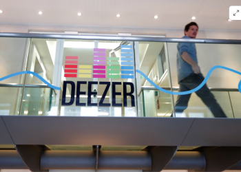 An employee passes by a logo at the music streaming services Deezer's headquarters in Paris, France, September 5, 2017. Picture taken September 5, 2017. REUTERS/Charles Platiau Purchase Licensing Rights