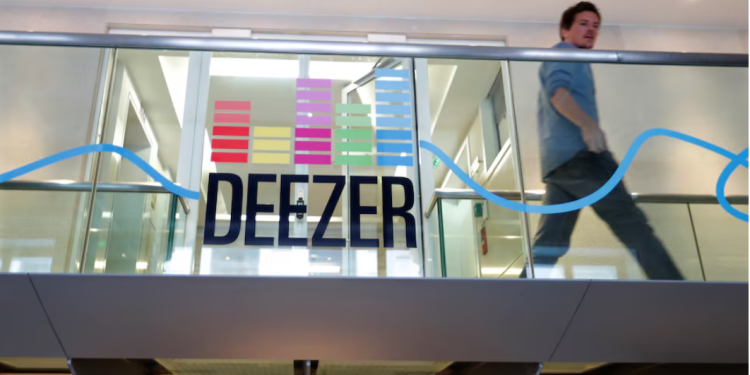 An employee passes by a logo at the music streaming services Deezer's headquarters in Paris, France, September 5, 2017. Picture taken September 5, 2017. REUTERS/Charles Platiau Purchase Licensing Rights