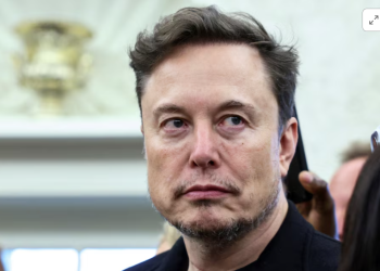 Elon Musk looks on as U.S. President Donald Trump meets South African President Cyril Ramaphosa in the Oval Office of the White House in Washington, D.C., U.S., May 21, 2025. REUTERS/Kevin Lamarque Purchase Licensing Rights