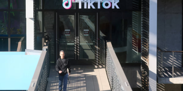 A man leaves the U.S. headquarters of the social media company TikTok in Culver City, California, U.S. January 17, 2025. REUTERS/David Swanson/File Photo Purchase Licensing Rights