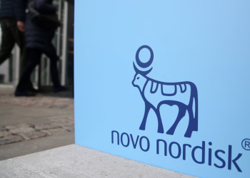 People walk past a sign for Novo Nordisk’s annual general meeting at the entrance to the venue in Copenhagen, Denmark, March 26, 2026. REUTERS/Tom Little/File Photo Purchase Licensing Rights