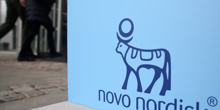 People walk past a sign for Novo Nordisk’s annual general meeting at the entrance to the venue in Copenhagen, Denmark, March 26, 2026. REUTERS/Tom Little/File Photo Purchase Licensing Rights