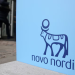 People walk past a sign for Novo Nordisk’s annual general meeting at the entrance to the venue in Copenhagen, Denmark, March 26, 2026. REUTERS/Tom Little/File Photo Purchase Licensing Rights