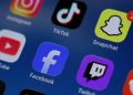 Instagram, TikTok, Snapchat, YouTube, Facebook, Twitch and Reddit applications are displayed on a mobile phone ahead of new law banning social media for users under 16 in Australia, in this picture illustration taken on December 9, 2025. REUTERS/Hollie Adams/Illustration/File Photo Purchase Licensing Rights