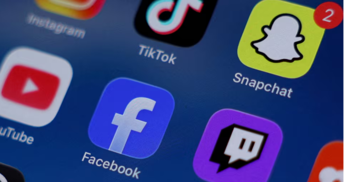 Instagram, TikTok, Snapchat, YouTube, Facebook, Twitch and Reddit applications are displayed on a mobile phone in this picture illustration taken on December 9, 2025. REUTERS/Hollie Adams/Illustration/File Photo Purchase Licensing Rights