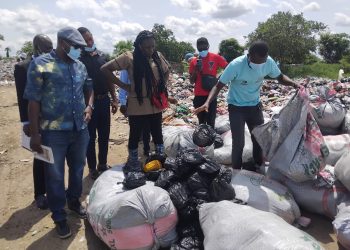 Security personnel at the dumpsite supervising the destruction of narcotic substances.