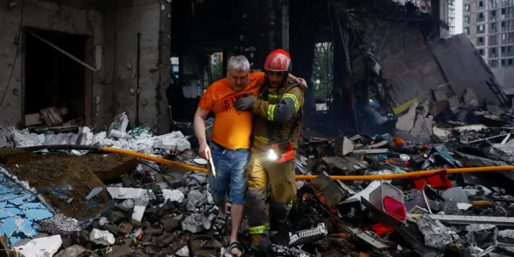 Photo credit: Reuters.
Kyiv emergency services were pulling survivors out of bombed-out buildings following early morning strikes on Monday