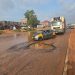 Wastewater takes over two lanes of road, while deep potholes worsen conditions